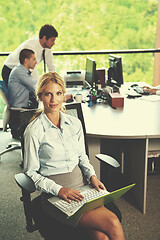 Image showing business woman with her staff in background at office