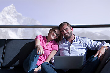 Image showing couple relaxing at  home using laptop computers