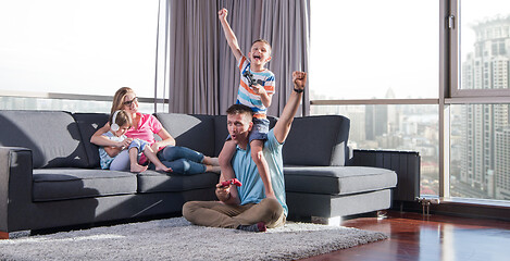 Image showing Happy family playing a video game