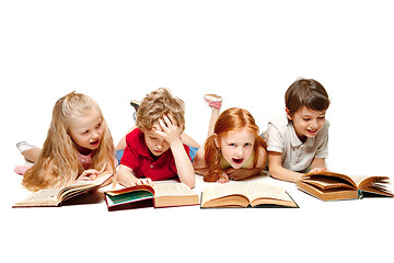 Image showing The kids boy and girls laying with books isolated on white