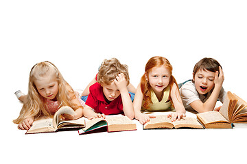 Image showing The kids boy and girls laying with books isolated on white