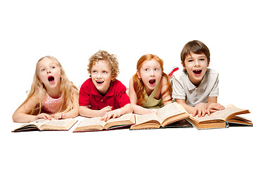 Image showing The kids boy and girls laying with books isolated on white