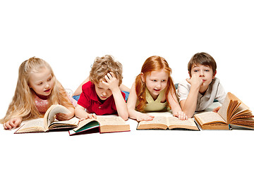 Image showing The kids boy and girls laying with books isolated on white