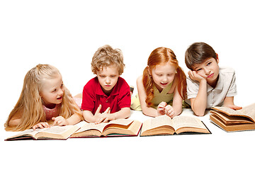 Image showing The kids boy and girls laying with books isolated on white