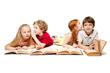 Image showing The kids boy and girls laying with books isolated on white