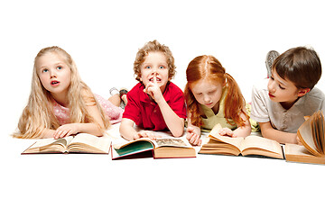 Image showing The kids boy and girls laying with books isolated on white