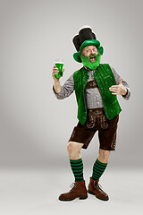 Image showing A man in a leprechaun hat at studio. He celebrates St. Patrick\'s Day.