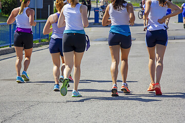 Image showing Group Young girls friends running on the city street