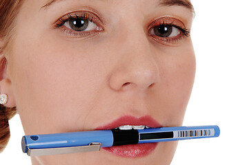 Image showing Closeup of woman's face with pen