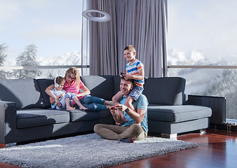 Image showing Happy family playing a video game