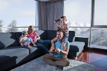 Image showing Happy family playing a video game