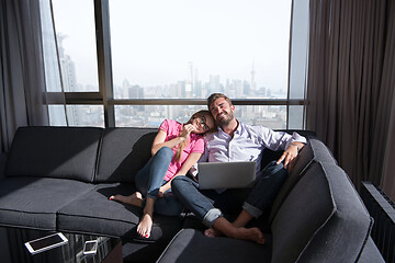 Image showing couple relaxing at  home using laptop computers