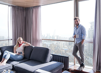 Image showing couple relaxing at  home using tablet computer