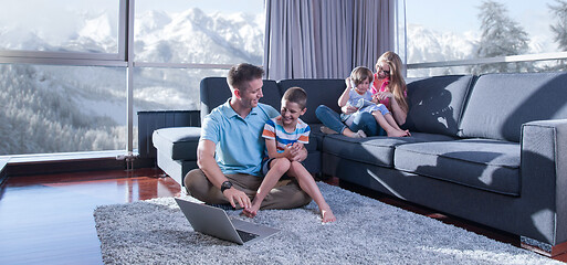 Image showing Happy family playing a video game