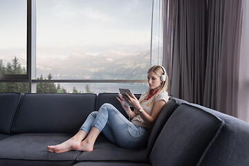 Image showing young girl enjoying music through headphones