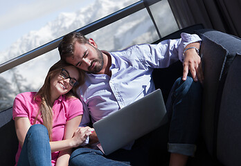 Image showing couple relaxing at  home using laptop computers