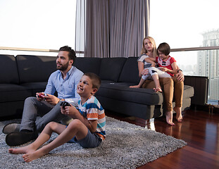 Image showing Happy family playing a video game