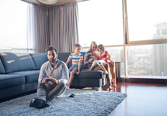 Image showing Happy family playing a video game