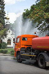 Image showing Work watering machine in city public park