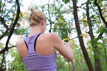 Image showing Training with fitness straps outdoors.