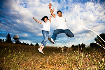 Image showing Asian couple jumping for joy