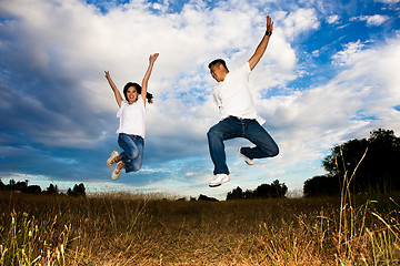 Image showing Asian couple jumping for joy