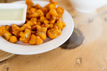 Image showing close up of cauliflower pakora with dip sauce