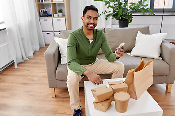 Image showing indian man checking takeaway food order at home