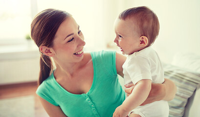 Image showing happy young mother with little baby at home