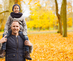 Image showing happy family having fun in autumn park