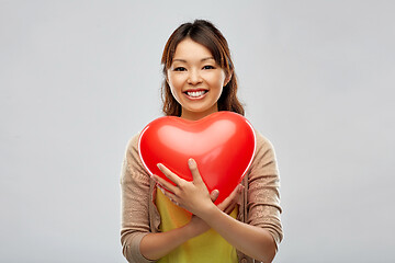 Image showing happy asian woman with red heart shaped balloon