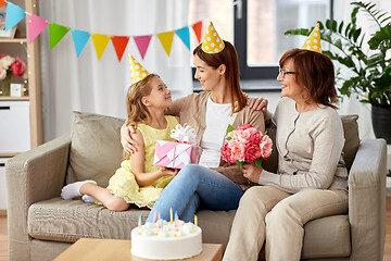 Image showing daughter with gift box greeting mother on birthday