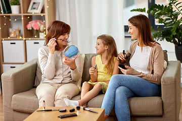 Image showing mother, daughter and grandmother doing make up