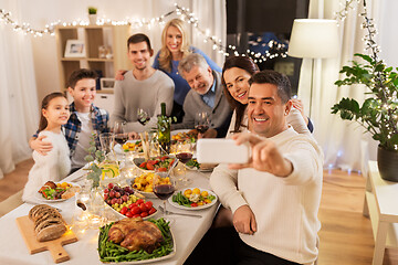 Image showing family having dinner party and taking selfie