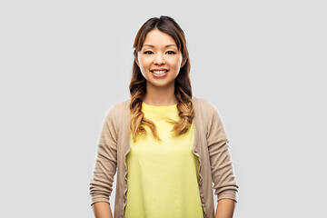 Image showing happy asian woman over grey background