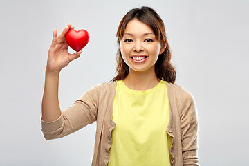 Image showing happy asian woman holding red heart