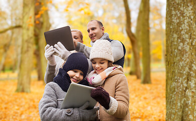 Image showing happy family with tablet pc in autumn park