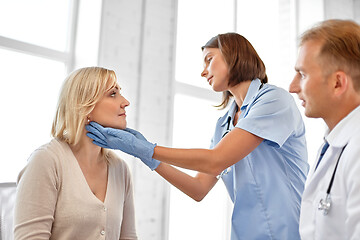 Image showing doctor checking patient\'s tonsils at hospital