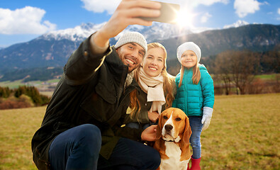 Image showing happy family with dog taking selfie in autumn