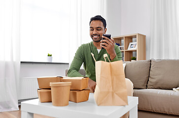 Image showing indian man checking takeaway food order at home