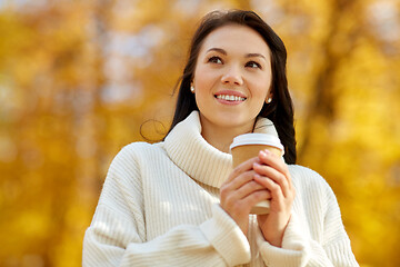 Image showing woman drinking takeaway coffee in autumn park