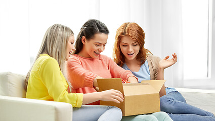 Image showing teenage girls or friends opening parcel box