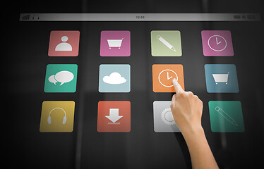 Image showing hand using interactive panel with app icons on it