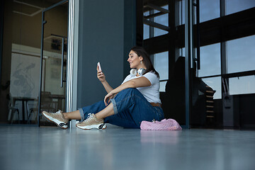 Image showing Young woman waiting for departure in airport, traveler with small baggage, influencer\'s lifestyle