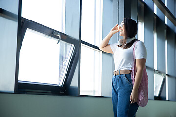 Image showing Young woman waiting for departure in airport, traveler with small baggage, influencer\'s lifestyle