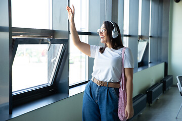 Image showing Young woman waiting for departure in airport, traveler with small baggage, influencer\'s lifestyle