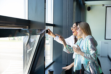 Image showing Young women waiting for departure in airport, traveler with small baggage, influencer\'s lifestyle