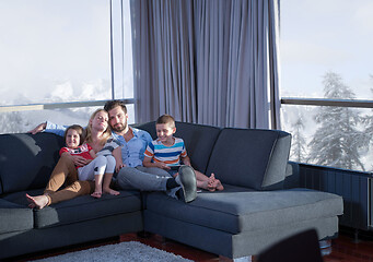 Image showing happy young couple spending time with kids at home