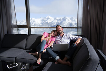 Image showing couple relaxing at  home using laptop computers