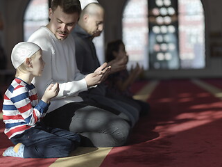 Image showing father and son in mosque praying